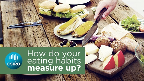 A table set with healthy eating options, a hand reaches in with knife to serve food.