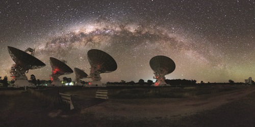 CSIRO's Compact Array in Australia under the night lights of the Milky Way.