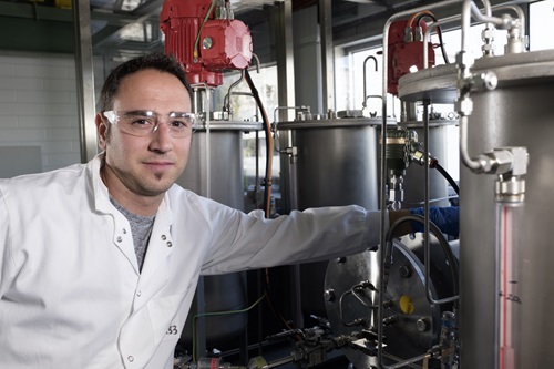 Ivan Martinez Botella standing next to FloWorks equipment. 