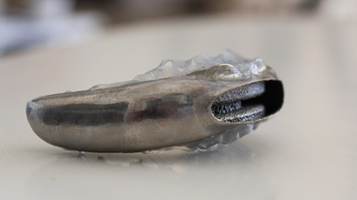 Side view of a 3D-printed titanium sleep apnoea device