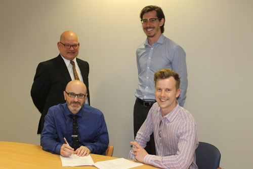 CSIRO's Andrew Stammer and Marcus Zipper signing the agreement with Byron Scaf and Daniel Pikler from Stile Education.