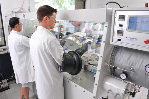 Two male researchers work in a lab environment.