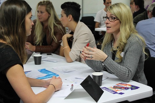 People sitting at a table during the Ribit’s Get Connected speed dating event. 
