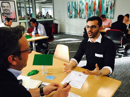 People sitting at a table during the Ribit’s Get Connected speed dating event. 