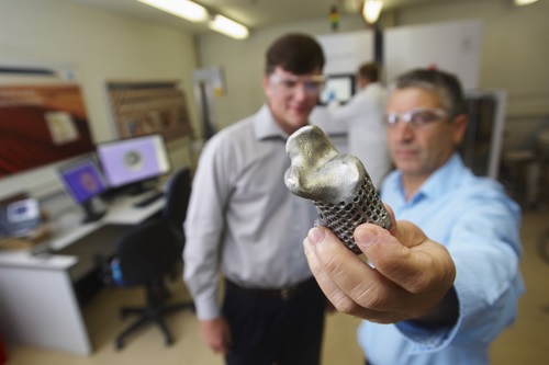 Chad Henry and Stefan Gulizia with the 3D printed titanium heal bone.