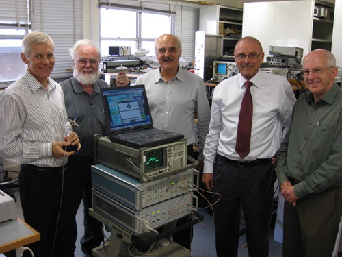 CSIRO's WLAN team standing in the lab with the WLAN testbed.