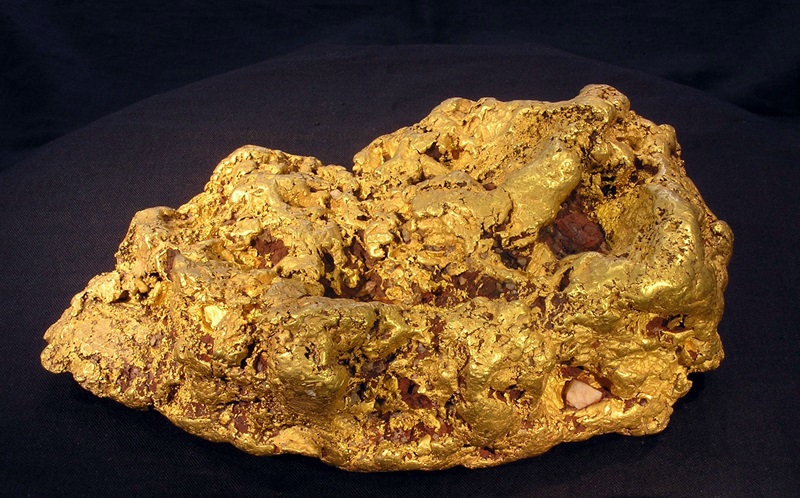 Gold nugget against a black background.