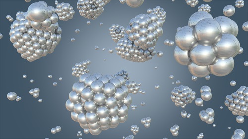 Graphic of nucleation and growth process of catalytic nanoparticles; consists of silver spheres representing molecules accreting into large and small masses.
