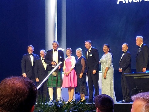 A group on stage receive the award in Dallas.