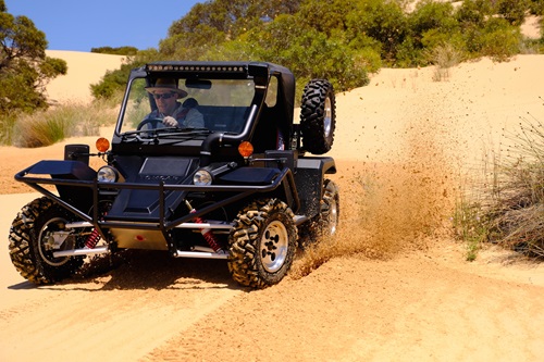 Person driving a Tomcar Australia off-road/off-grid vehicle.