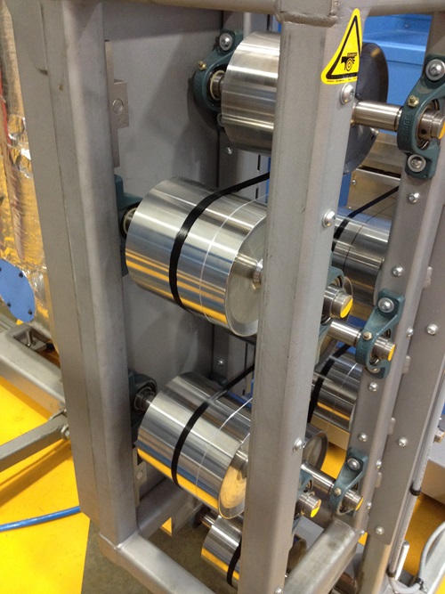 Close up view of the machinery used in the manufacture of carbon fibre including drums used to collect finished threads.
