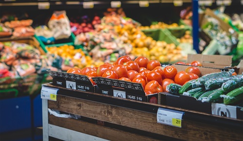 Shelves containing fruit and vegetables at a supermarket. 