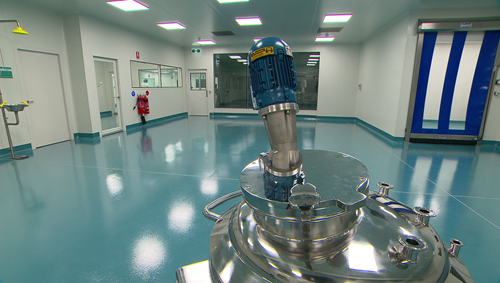 View of laboratory with equipment in foreground. 