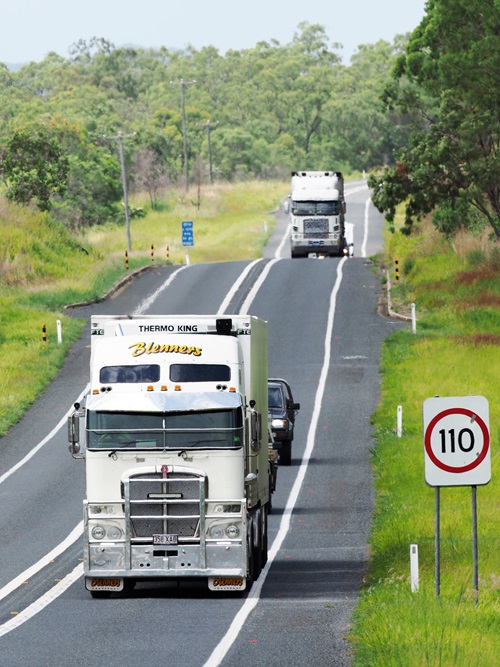 Trucks drining aling a highway in outback Australia.