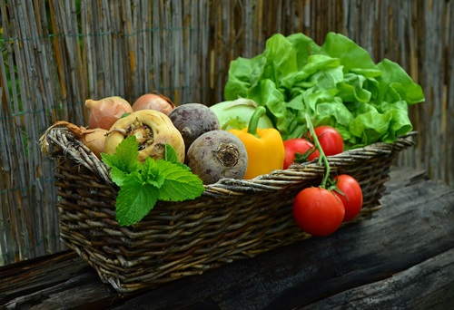 Assortment of fresh fruit and vegetables in a basket. 