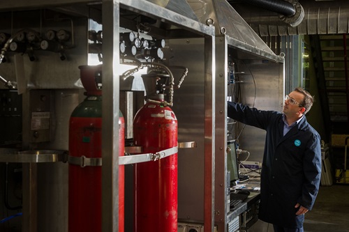 Scientist inspecting equipment.
