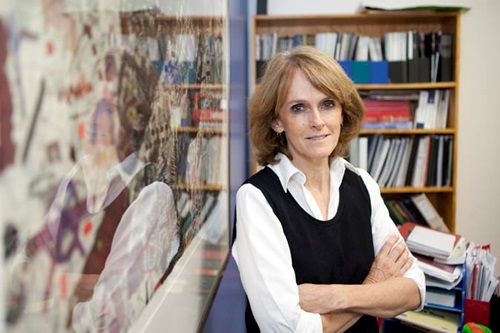 Cathy Foley standing in office in front of a book case.