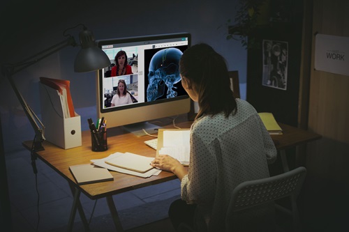 Person sitting at a desk using the Coviu video telehealth platform.
