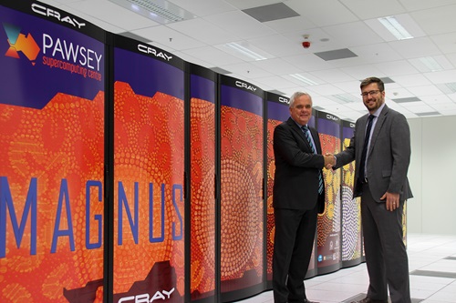 Two men in suits shake hands in super computer data centre.