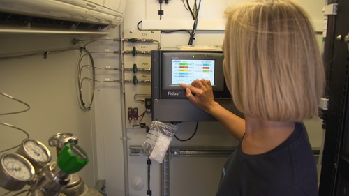 Scientist using air quality monitoring equipment. 