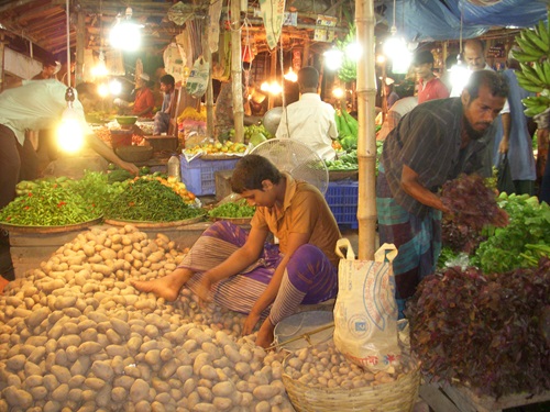 People working at a food market in Bangladesh.