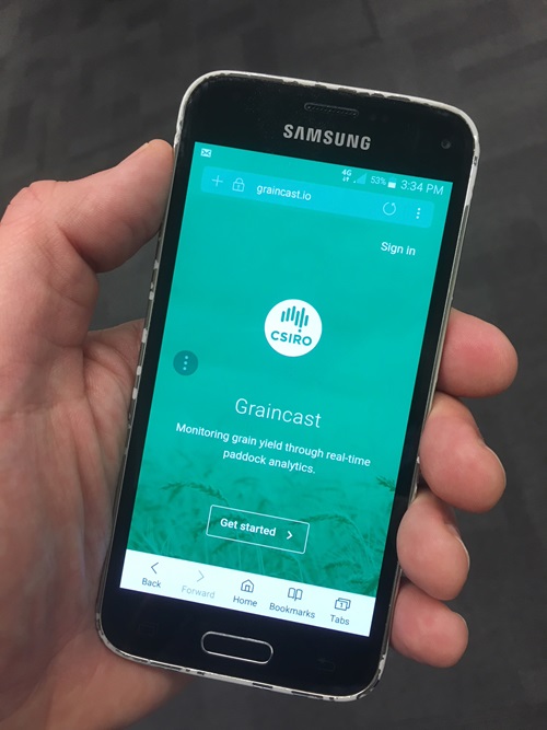 Hand holding a smart phone with the Graincast app showing on the screen.