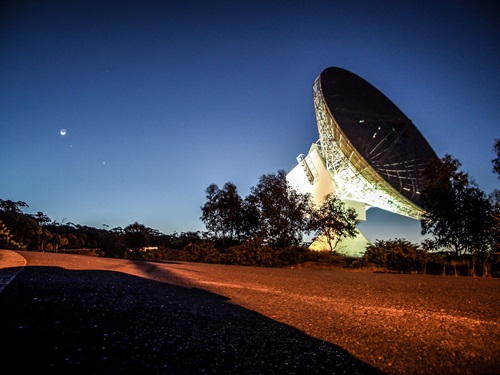 Radio telescope at night.