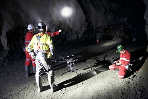 People underground setting up Emesents Hovermap to explore an underground mine.