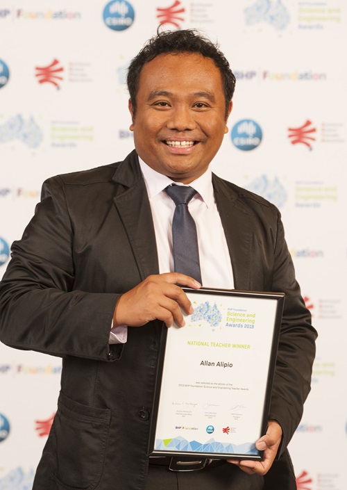 Allan Alipio holding a certificate.