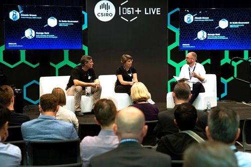 People talking to an audience on a panel.
