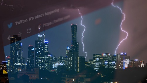 View of lightning stiking city buildings through a high rise window. 