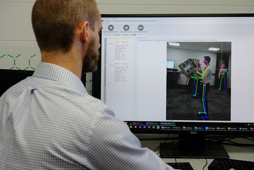 Person working in front of a computer screen.