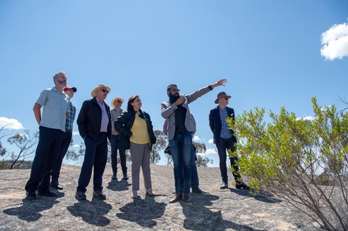 Group of people standing on a rock outcrop in Kooyoora State Park, Australia.
