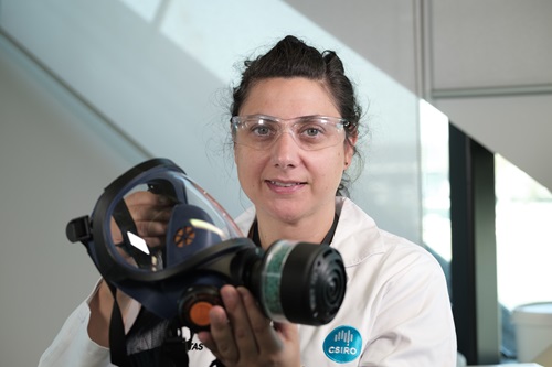 Scientist holding a gas mask.