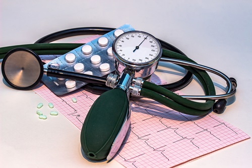 blood pressure monitor and tablets on a table