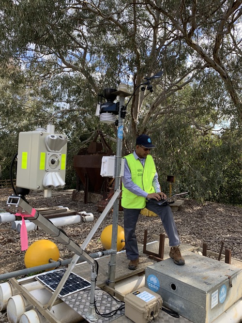 Researcher building equipment beside a lake