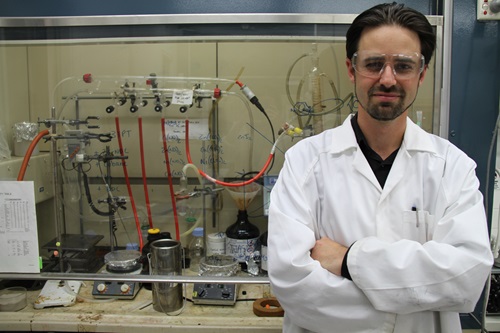 Scientist in front of fume hood
