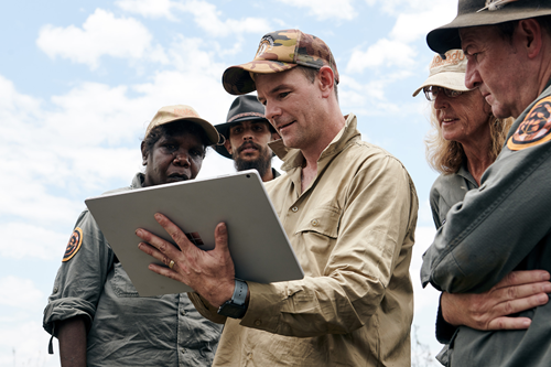 People gathered around a digital dashboard