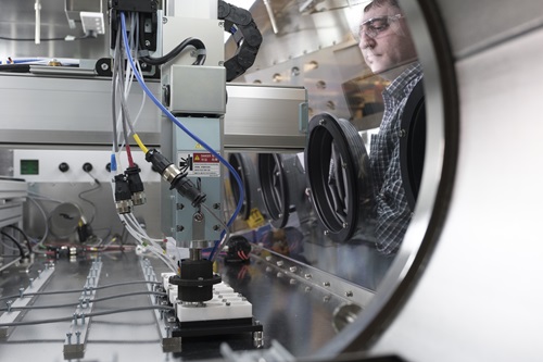Scientist operating a robot.