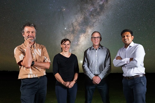 Antony Schinckel, Rebecca Wheadon, Aurecon, David Luchetti and Shandip Abeywickrema, standing in front of a photgraph of the Milky Way.