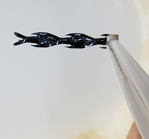 GraphON coated static mixer being held in the end of a pair of tweezers. 