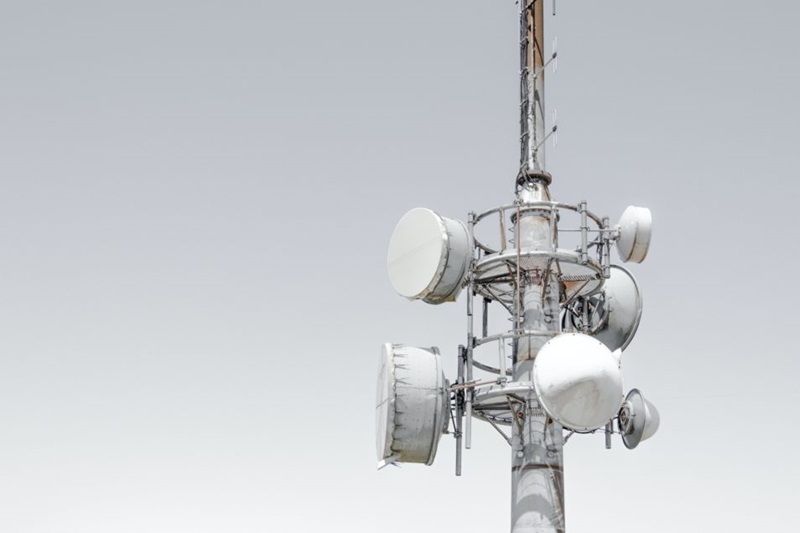 Mobile phone tower in front of an overcast sky