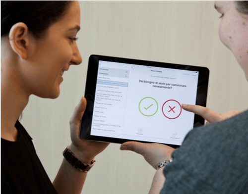 Two people using an ipad.
