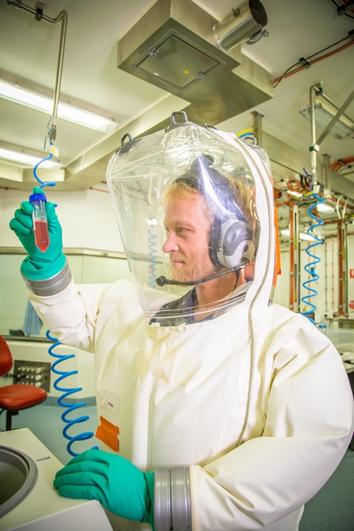 Scientist in hazmat suit working in the secure area at CSIRO's Australian Centre for Disease Preparedness (ACDP).