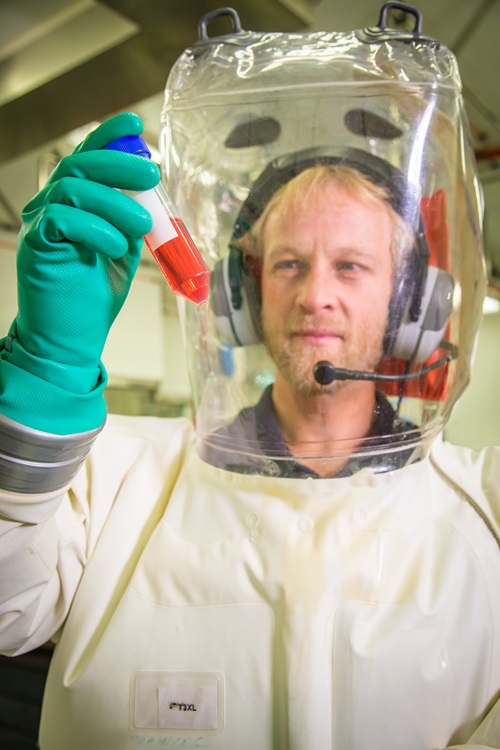 Scientist in hazmat suit working in the secure area at CSIRO's Australian Centre for Disease Preparedness (ACDP).