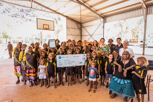 Group shot of people at the Utju/Areyonga School holding a giant novelty cheque.