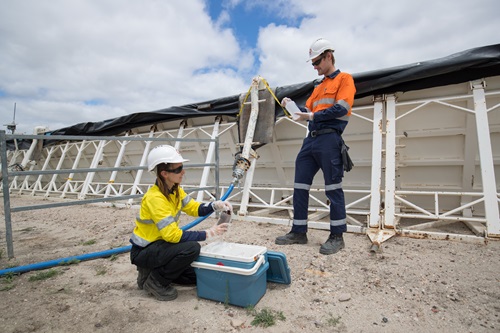 CSIRO scientists collect water samples at a CSG well site.