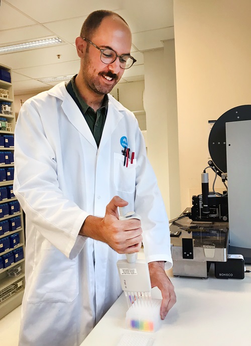 Scientist injects rainbow liquid into caps