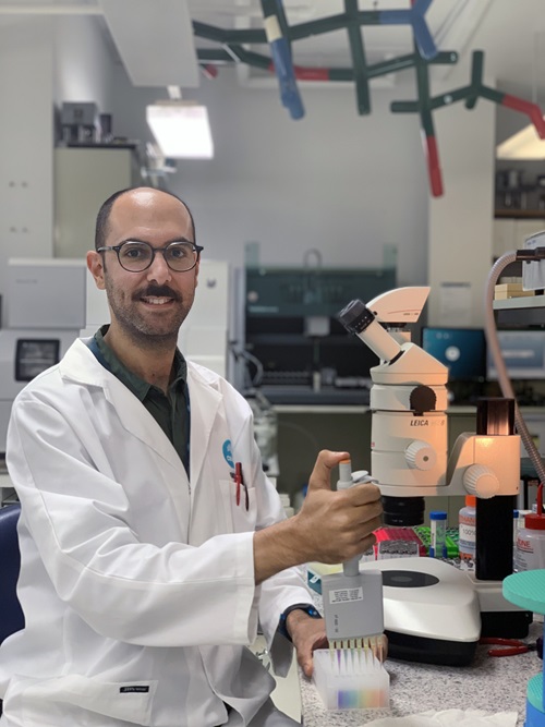 Scientist injects rainbow liquid into caps