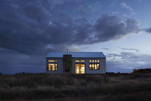 house in the evening with lights on
